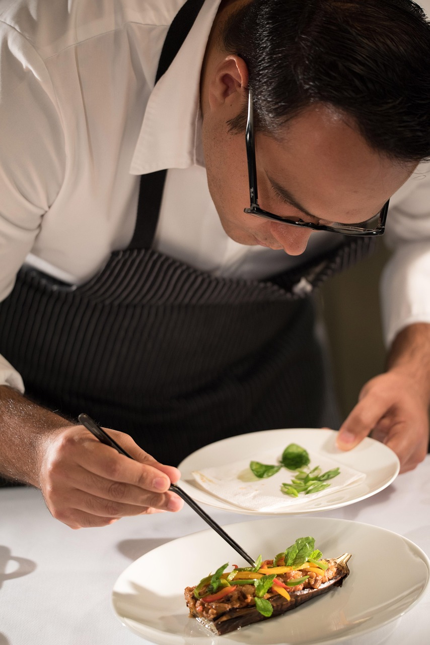 man putting food on plate to plate it