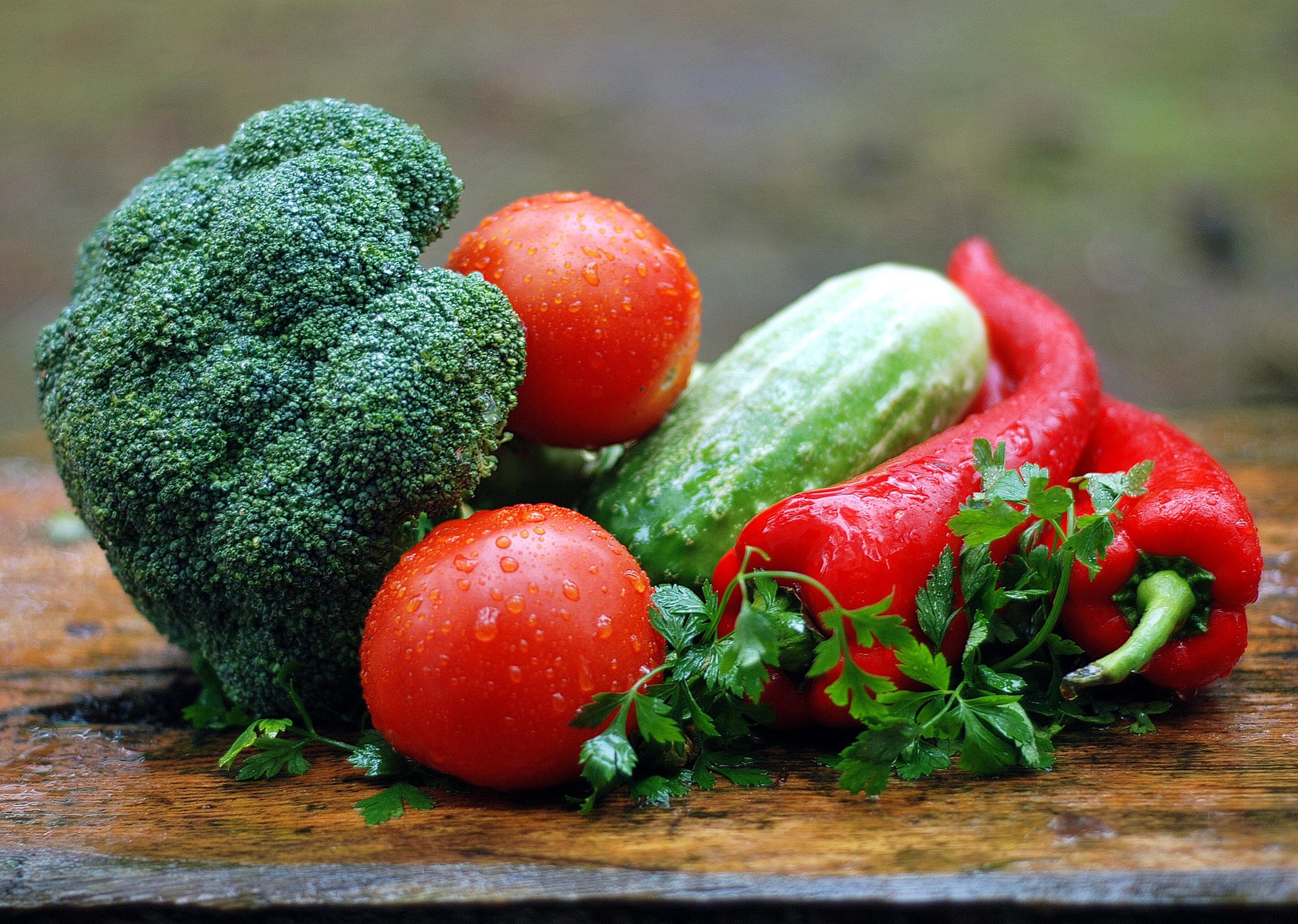 brocolli tomatoes peppers and herbs on table